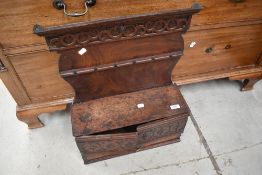 A composite period oak spoon/pipe rack with cupboard/drawer base, width approx. 45cm