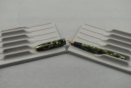 A Conway Stewart 75 leverfill fountain pen in green marble with single narrow band to cap having a
