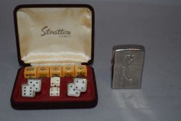 A set of cased gambling dice by Stratton with similar dice and cufflinks also golf theme lighter