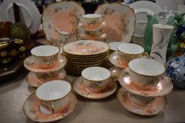 An early 20th century partial tea service, marked GDA France to underside, having pale coral
