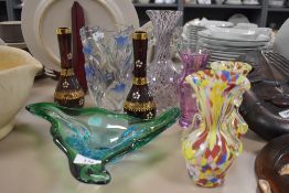 A collection of art glass to include seven colourful vases and a bowl.