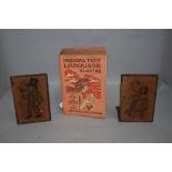 A pair of book ends with tramp style image and a copy of Nouveau Petit Larousse Illustre