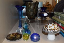 Three paperweights and similar glassware items.