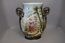 A porcelain mantle vase having hand painted decoration of two 18th century lovers with landscape