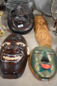 Four decorative carved wooden masks.