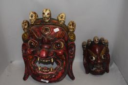 Two hand carved wooden ethic tribal or ritual masks possibly Bali or Indonesian