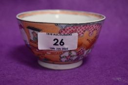 A Chinese style tea bowl highly decorated with peach ground and traditional scenery