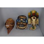 Three wooden hand carved tribal ethnic or ritual masks including a Hindu Ganesh