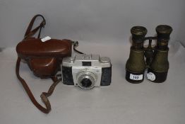 A pair of early 20th century brass binoculars with a Agfa Silette camera