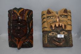 Two hand carved wooden ethnic tribal or ritual masks possibly native American