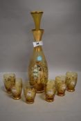 A Venetian amber glass decanter set with floral and gilt decoration
