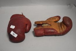 A pair of vintage leather boxing gloves