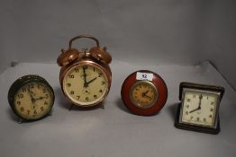 A selection of art deco design alarm and travel clocks including Peter and Vegila