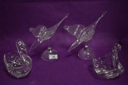 A pair of art glass swans and two similar swan design glass works
