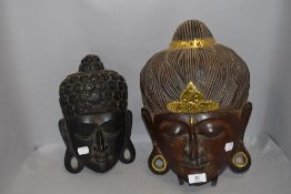 Two tribal masks carved from ethnic hard woods possibly Bali or Indonesia