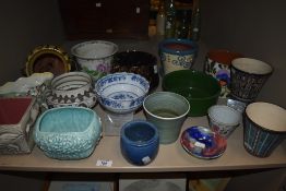 An assortment of studio pottery plant pots and mid century ceramics,including Ambleside pottery