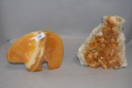 A geological mineral geode sample and a similar hand carved stone bear figure