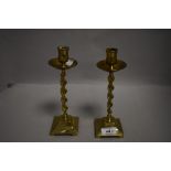 A pair of Victorian brass candlestick holders having barely twist columns.