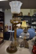 A Victorian oil lamp having Greek style column base with Vaseline glass light shade