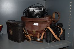 A Yashica IC Lynx 5000E camera along with a pair of USSR 8x30 binoculars