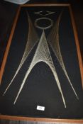A mid century geometric nail and string art picture of an angel