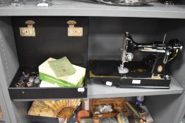 A 20th century portable electric sewing machine by Singer with case and box model no. 221K1