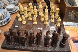 A modern chess set with a medieval figure theme and matching board
