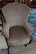 A traditional arm chair in beige fabric.