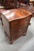 A reproduction Regency yew wood serpentine front chest of three drawers, width approx 55cm