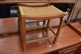 A traditional strung stool having Arts and Crafts style frame