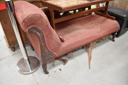 A late Victorian chaise longue, with scrolled over 'arm' and turned supports, requires re-