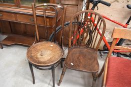 A vintage wheelback chair and a bentwood chair