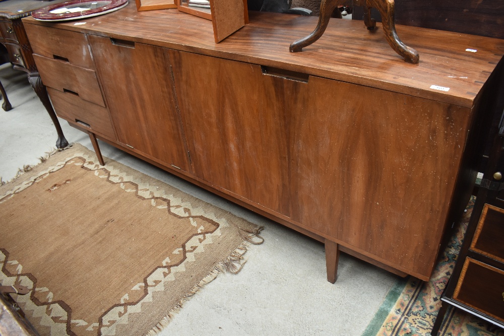 A vintage Long John style sideboard having recessed handles, three drawers and triple cupboard,