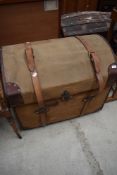 A vintage canvas covered dome top trunk