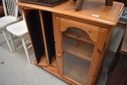 A modern pine HiFi cabinet with revolving CD storage