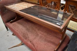 A 1970's tile and glass topped teak coffee table