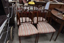 A set of four reproduction Regency dining chairs