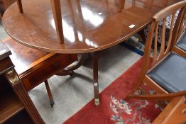 A reproduction Regency extending dining table of typical design