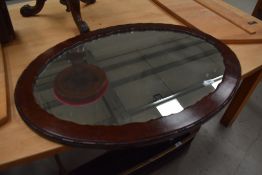 A 20th Century mahogany oval wall mirror