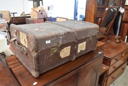 A vintage travel trunk, bearing railway labels etc