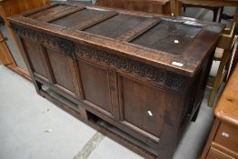 A period oak kist having four panelled lid and front, dummy drawer fronts from base included