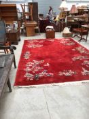 A Chinese carpet square having red ground and foliate and boat decoration , approx. 360 x 250cm