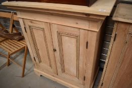 A 19th Century and later stripped pine vestry or similar cabinet, having rectangular top width