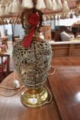 A vintage brass urn shaped table lamp, pierced phoenix decoration