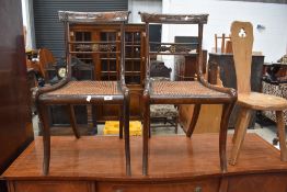 A pair of Regency style mahogany dining chairs having bergere canework seats