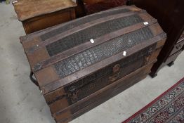 A dome top travel trunk , having alligator skin type covering