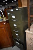 A traditional four drawer filing cabinet, in military green