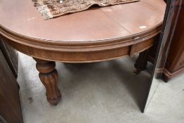 A Victorian extending mahogany dining table with fluted baluster legs on castors.