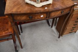 A reproduction Regency bow front side table with double frieze drawer