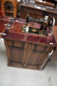 A late 19th or early 20th Century Jones sewing machine in mahogany cabinet